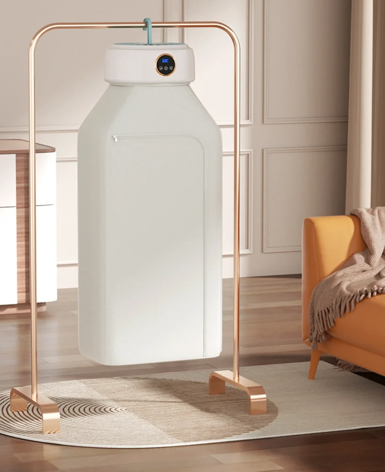 Portable clothes dryer hanging from a clothes rail in a living room