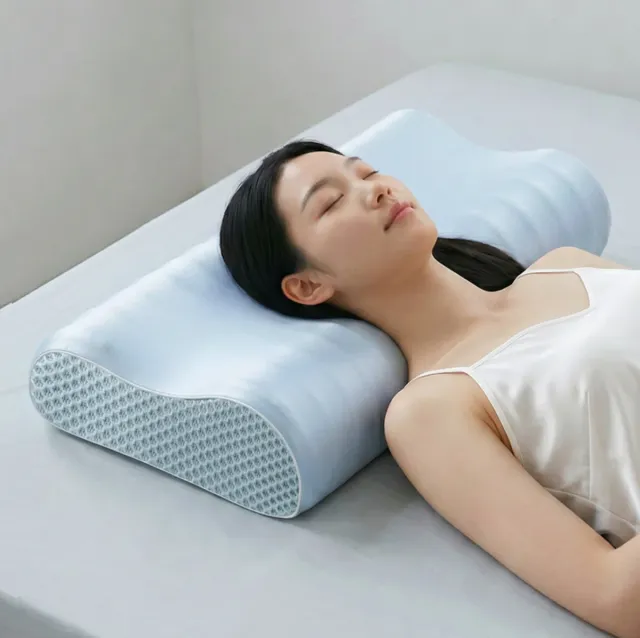 Woman sleeping on her back on the light blue contour memory foam pillow