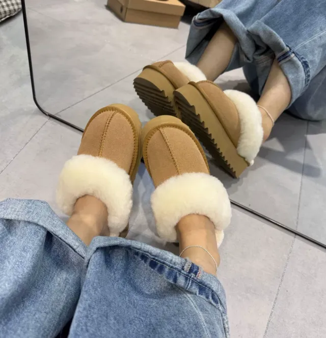 Chestnut platform slippers with fluffy faux-fur cuffs, worn with jeans