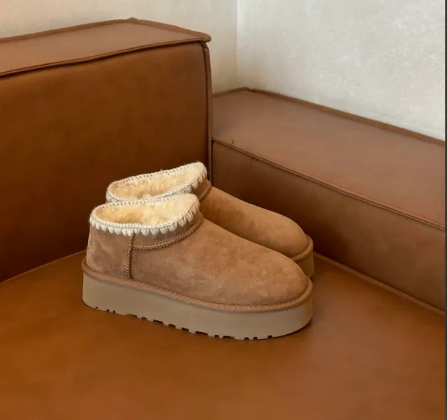 Chestnut stitch-trim mini platform boots on a tan leather sofa